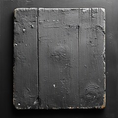 A textured black wooden board with a rustic finish, suitable for various creative projects.