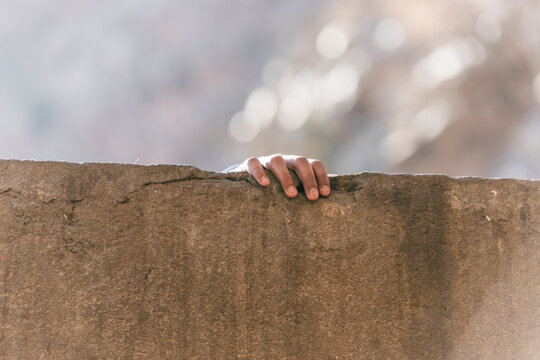 View of textured wall with hand gripping, Shri Galta Peeth, Monkey Temple, Jaipur, Rajasthan, India.