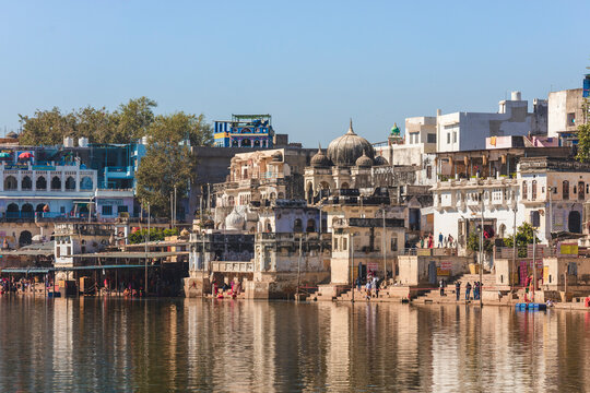 Pushkar, India - 14 December 2024: View of colorful buildings and traditional architecture along the waterfront of Ghat, Pushkar, India.