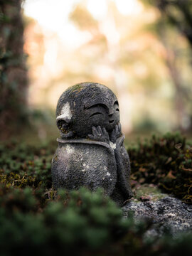 View of a little Jizo buddha statue in a japanese garden at Enkoji temple, Kyoto, Japan