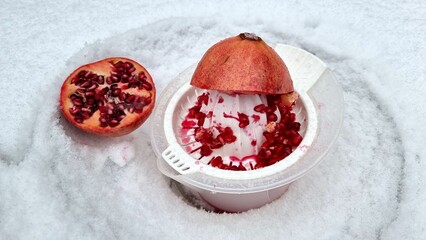 squeezing and juicing pomegranates