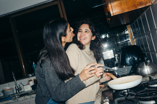 Girlfriends Cooking pancakes In The Kitchen.
