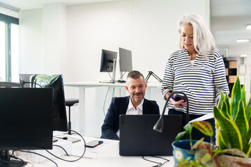 Professional Colleagues Collaborating in Modern Office Setting