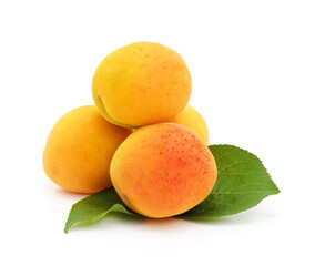 Heap of ripe apricots with leaves.