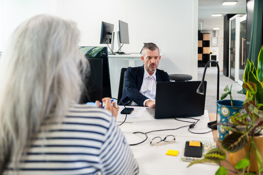 Business Colleagues Working Together in Office Setting