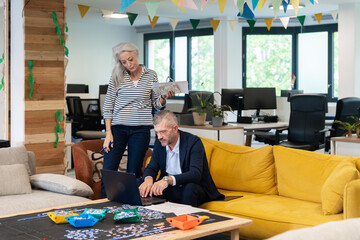 Professionals Reviewing Data on Laptop in Collaborative Office