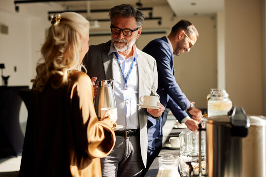 Colleagues help themselves to drinks on a break