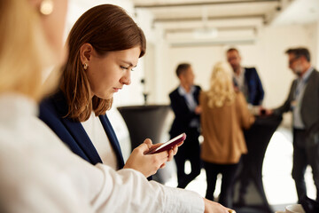 Businesswoman uses her phone