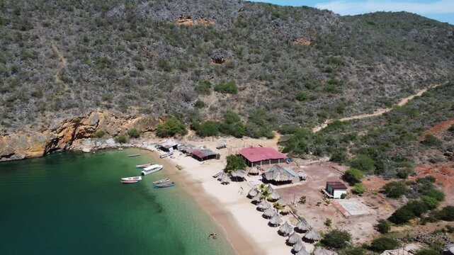 Majestic cliffs and turquoise waters at Playa Manare, Mochima National Park, Venezuela. A breathtaking drone view of coastal rock formations, lush vegetation, and pristine ocean scenery