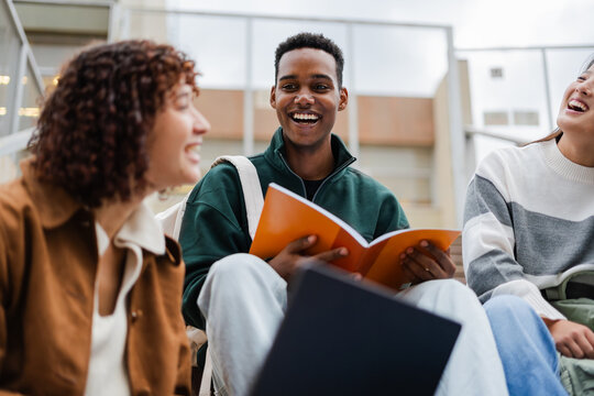Male And Female Students Discussing At College Campus