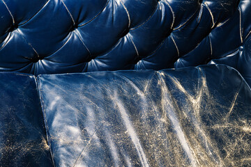 Flash photograph of faded navy blue leather couch