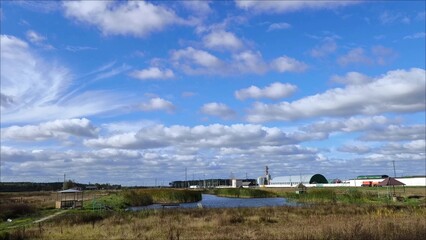 The road outside the city. Highway along the village in the countryside. View from the right side window of a moving car. Sunny weather, beautiful lake landscape