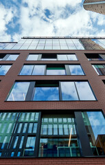 Modern office building on a sunny day with a blue sky. Facade of a modern apartment building