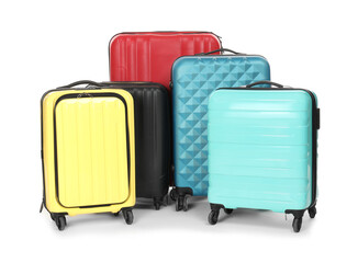Many closed colorful suitcases isolated on white