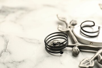 Stylish presentation of rings on white marble table, closeup. Space for text