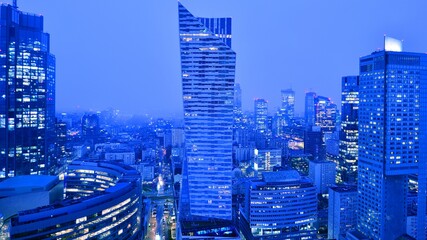 Aerial photography of modern architectural landscapes  in the fog at night. Lights in the windows...