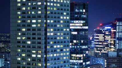 Aerial photography of modern architectural landscapes at night. Lights in the windows of buildings....