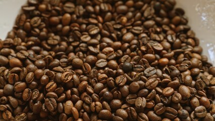Closeup image of roasted coffee beans showcasing their rich brown color and aromatic texture