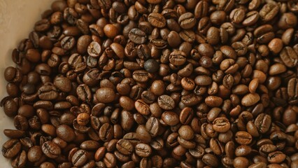 Close up photo of roasted coffee beans with rich brown hues, showcasing texture and freshness