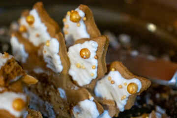 Deliciously decorated gingerbread cookies adorned with icing and golden pearls, perfect for festive occasions and celebrations.