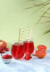 Pomegranate fruit juice and ingredients, summer pomegranate drink on bright table, detox diet and weight loss concept, healthy and natural food, source of vitamin C, selective focus,