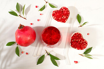 Fruit pomegranate juice and ingredients, summer pomegranate drink on bright table, detox diet and...