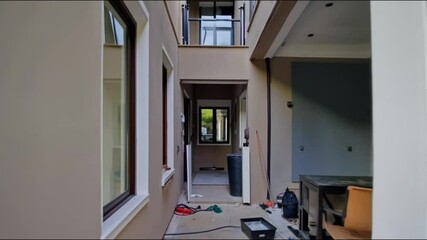 A home renovation project transforms an old exterior into a sleek, modern apartment, showcasing architectural updates and contemporary design.