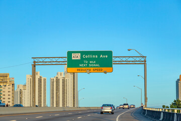 traffic sign at the highway in Miami with A1A, Collins ,avenue, reduced speed, next signal sign