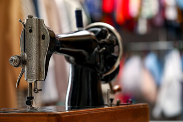 Vintage sewing machine with thread in workshop, closeup. Space for text