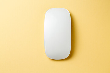A sleek, minimalist white device rests on a vibrant yellow background, embodying simplicity and modern design, ideal for tech and lifestyle themes.
