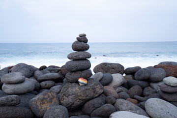 Balance stone tower on sea shore