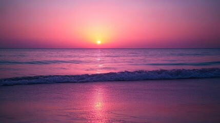 Fototapeta premium Pink sunset over calm ocean waves, sandy beach.