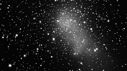 Obraz premium Faint, elongated galaxy with scattered stars in a dark night sky.