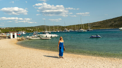 Primosten Croatia July 30, 2024, Idyllic Beach on Mediterranean Sea Coast Near Medieval Primosten City in Croatia. Summer Holidays Travel Destination Tourists Sunbathing and Enjoying Mala Raduca Beach