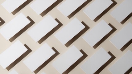 Aerial view of white rectangular cards arranged diagonally on a beige background, creating a modern and minimalist aesthetic.