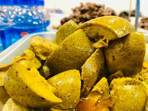 Closeup Mango Picklel. Homemade Mango Pickle or aam ka achar Kairi Loncha with Ingredients. Spicy avakaya raw mango pickle stored in a traditional jar. Selective focus.