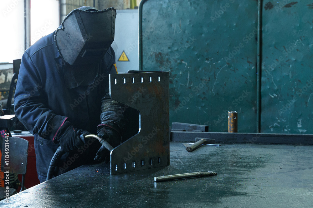 Poster worker engaging in metal fabrication using welding techniques in a workshop