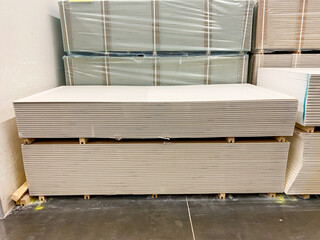 A carefully stacked arrangement of drywall sheets forms a robust and sturdy structure, which is constructed from this essential and widely utilized building material known in the industry