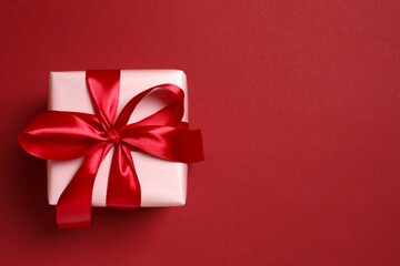Beautiful gift box on red background