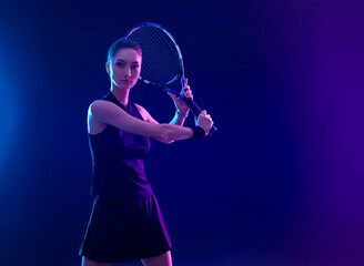 Padel tennis player with racket on tournament. Girl athlete with paddle racket on court with neon...