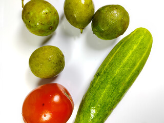 cucumber, tomato and lime on white background