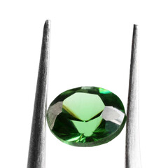 Tweezers with shiny green gemstone isolated on white