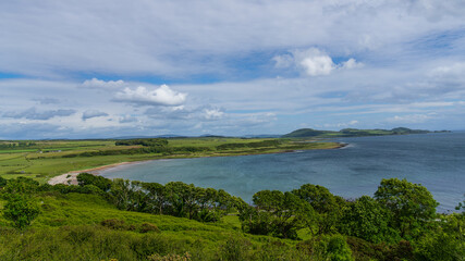 Scalpsie Bay, Isle of Bute, Scotland - June 8, 2024: A breathtaking coastal landscape featuring the tranquil Scalpsie Bay on the Isle of Bute. 