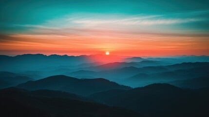 Obraz premium Breathtaking sunset over misty mountain ranges, enveloped in hues of blue and orange.