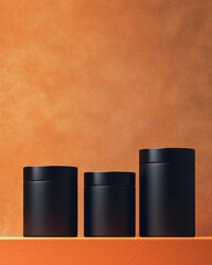 Three stylish black containers of varying sizes against a warm orange background.