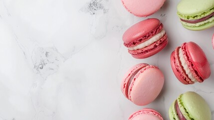 Fototapeta premium Pink and green macarons on marble background, minimalistic food composition, flat lay dessert layout, French pastry template, colorful gourmet snacks, copy space for text