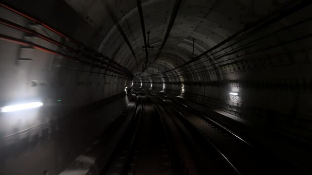 Back cabin view of driverless metro train moving through underground tunnel. Automated advanced transportation system, subway. High quality 4k footage