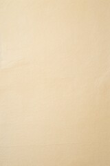Fototapeta premium Beige color textured crumpled paper background