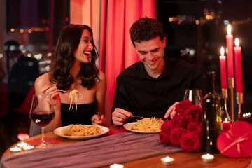 Handsome man and pretty woman dinning at restaurant, celebrating Valentine's Day together, lovers...