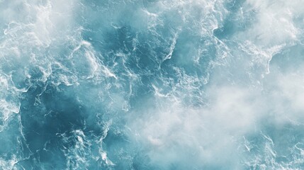 Fototapeta premium Aerial view of turbulent ocean waves in striking shades of blue and white, creating a dynamic and serene aquatic scene.